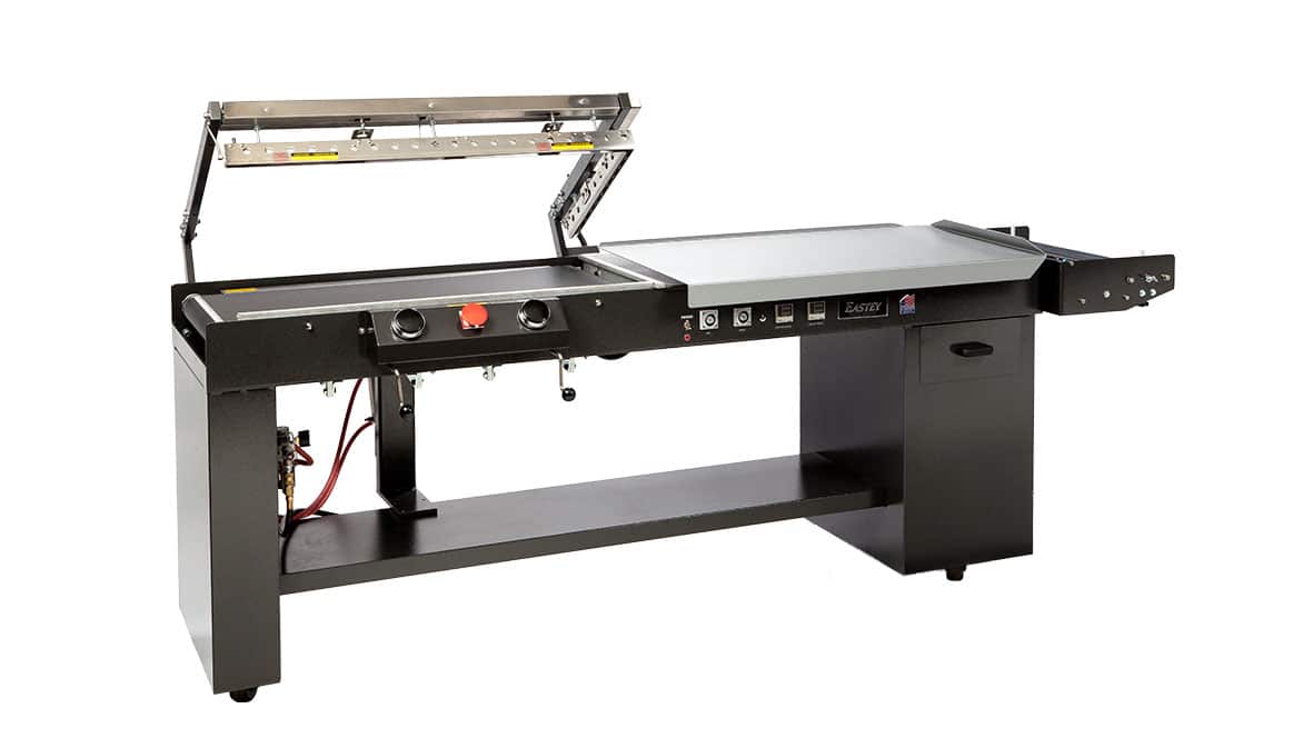 Industrial sealing machine with open lid.