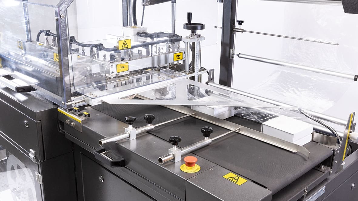 Packaging machine with conveyor and controls.