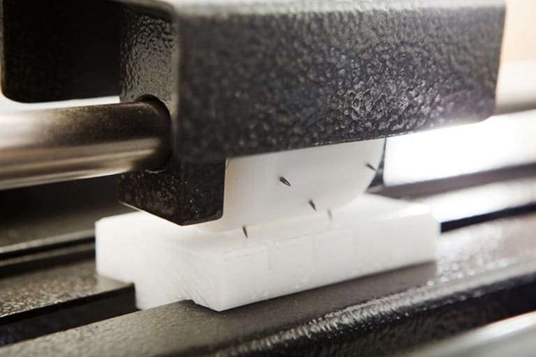 Adjustable pin perforator provides air evacuation in shrink film