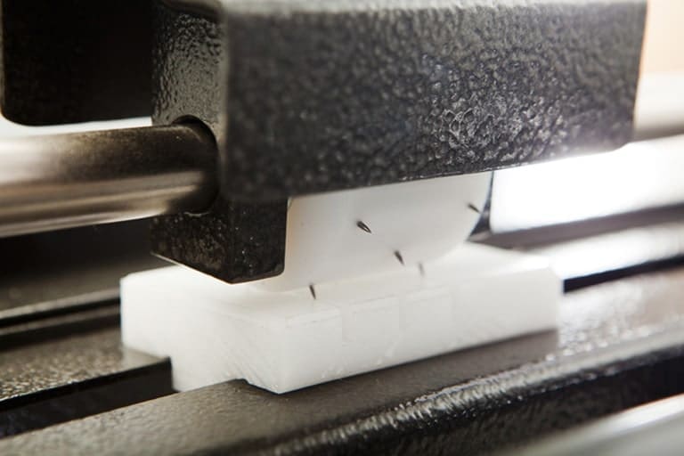 Adjustable pin perforator provides air evacuation in shrink film