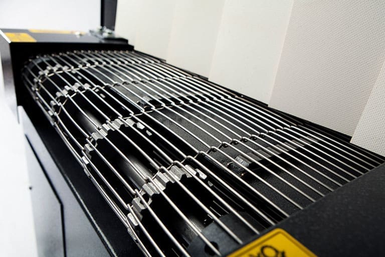 Stainless steel mesh belt conveyor on a shrink tunnel