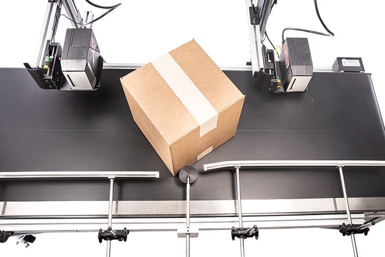 Box on conveyor belt under scanners.
