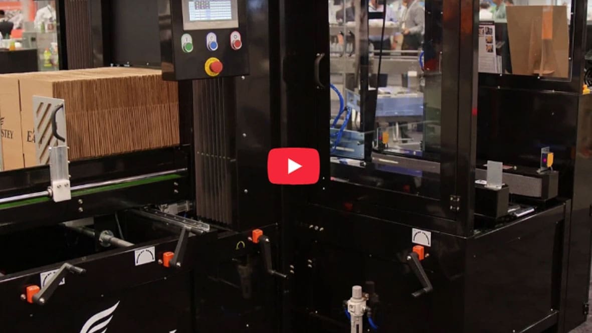 Packaging machine with cardboard boxes in factory.