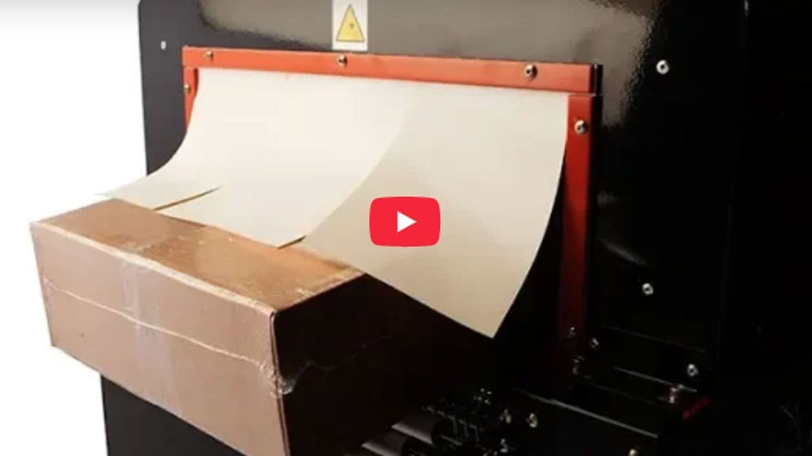 Cardboard box being processed by machine.
