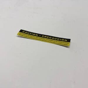 Yellow caution label on a white surface.