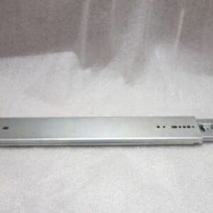 Metal drawer slide on a gray surface.