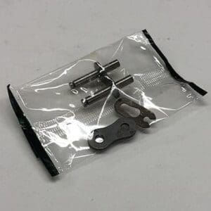 Here's a short alt tag for the image: Motorcycle chain repair kit parts.