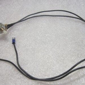Electrical wires with connectors on textured surface.