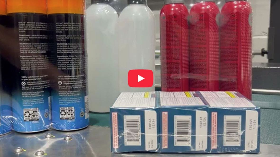 Bottles and boxes on a conveyor belt.