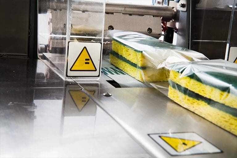 Bundled sponges being shrink wrapped
