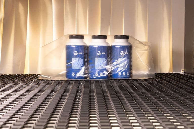 Shrink wrapped products entering a shrink tunnel