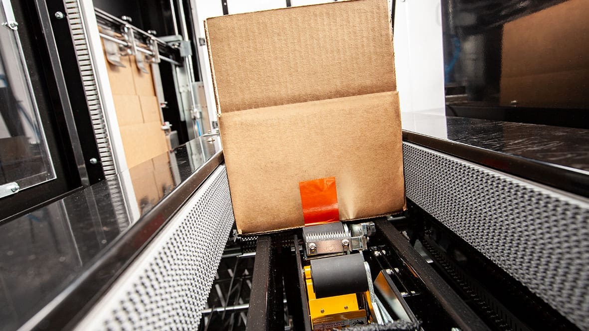 Cardboard box on automated conveyor belt.