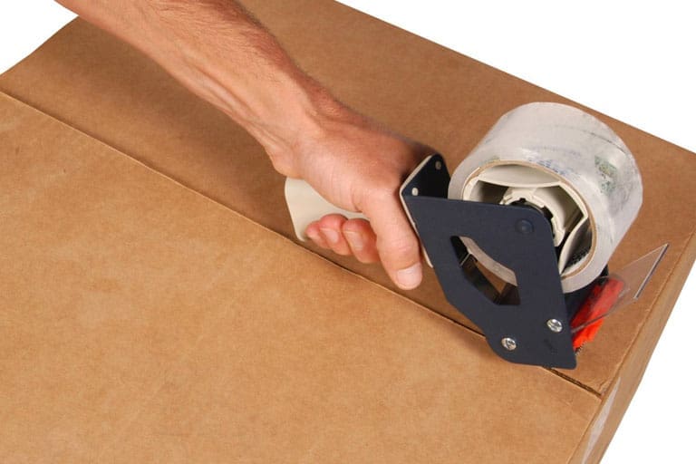 Example of someone manually taping a box