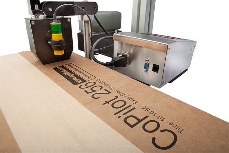 Industrial printer printing on a box